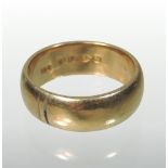 A large 18 carat gold gentleman's wedding band,