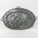 An early 20th century pewter plaque, of oval shape, with entwined twig handles,