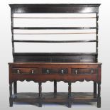 An 18th century oak dresser, with an open plate rack,