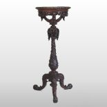 An ornate early 20th century carved mahogany jardiniere stand, with vine decoration,