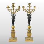 A pair of 19th century French Empire bronze and gilt metal figural candelabra,