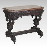 A 19th century heavily carved dark oak centre table, on dolphin supports, united by a stretcher,