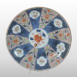 An 18th century Japanese Imari dish, of dished circular shape, with segmented decoration,