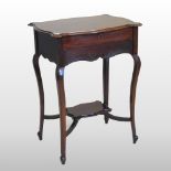 An Edwardian mahogany ladies writing desk, with a shaped top, on cabriole legs,