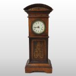 A 19th century walnut cased miniature Grandfather clock, having a painted dial, with Roman hours,