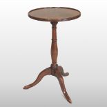 A George III mahogany occasional table, with a hinged dished circular top,