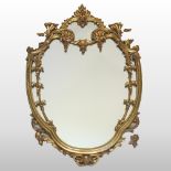 An early 20th century carved pine and gilt gesso shield shaped wall mirror,