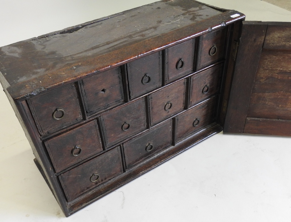 An 18th century carved oak spice cabinet, fitted with an arrangement of twelve short drawers, - Image 6 of 8