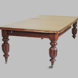 A large 19th century mahogany pull out extending dining table, with two additional leaves,