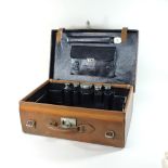 An early 20th century brown leather travelling vanity case, with a fitted interior,