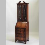 A reproduction mahogany bureau bookcase, of narrow proportions,