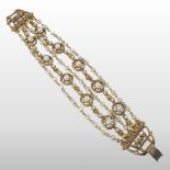 A gilt metal and pearl five strand bracelet, with a hinged clasp,