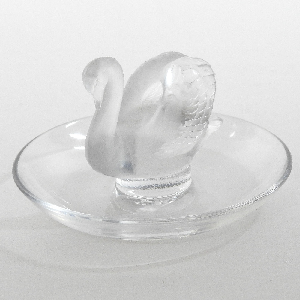 A Lalique frosted glass pin tray, in the form of a swan, on a dished base,