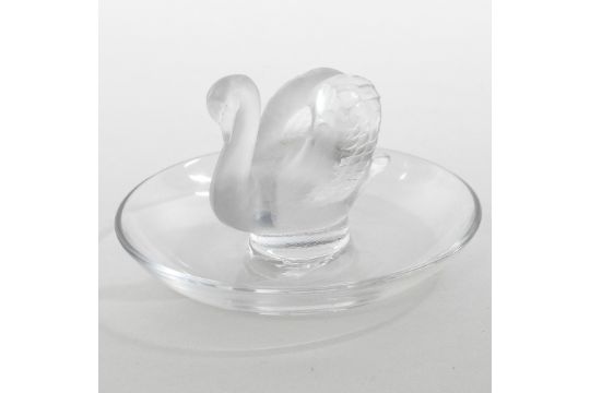 A Lalique frosted glass pin tray, in the form of a swan, on a dished base,