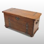 An elm and metal bound coffer, with a hinged lid, flanked by carrying handles,