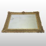 An early 19th century ornate gilt gesso wall mirror,