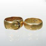 A gold wedding band, of buckle design, marked indistinctly,