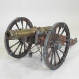 A Louis XIV style brass replica wooden model of a field cannon, with metal mounts,