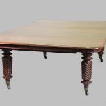 A large 19th century mahogany pull out extending dining table, to include three additional leaves,