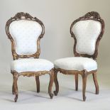 A pair of 19th century Italian carved and gilt side chairs, each upholstered in blue,
