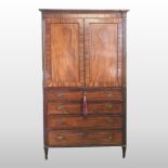 A large Regency mahogany inverted breakfront linen press, in the manner of Gillows,