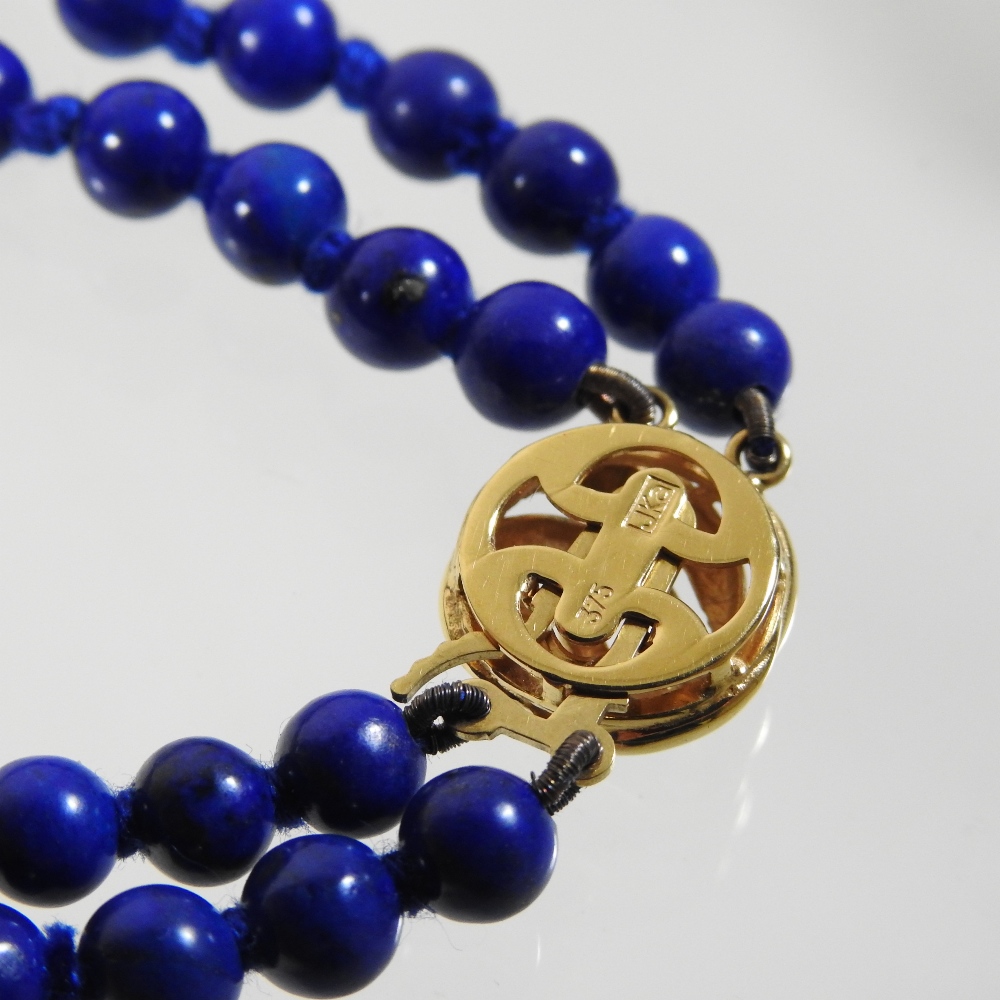 A lapis lazuli double strand bead necklace, with a 9 carat gold clasp, - Image 5 of 5