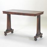 A Regency rosewood centre table, with a rectangular top, on a tapered end supports,