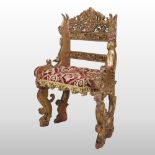 An 18th century Italian carved and giltwood throne chair, decorated with putto,