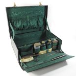 An early 20th century black leather travelling vanity case,
