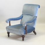 A Victorian blue upholstered armchair, on turned mahogany legs,