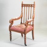 A Victorian carved light oak open armchair,