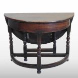 A 17th century and later oak credence table, with a hinged top, on turned legs,