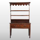 An 18th century oak dresser, of small proportions, having an open plate rack,