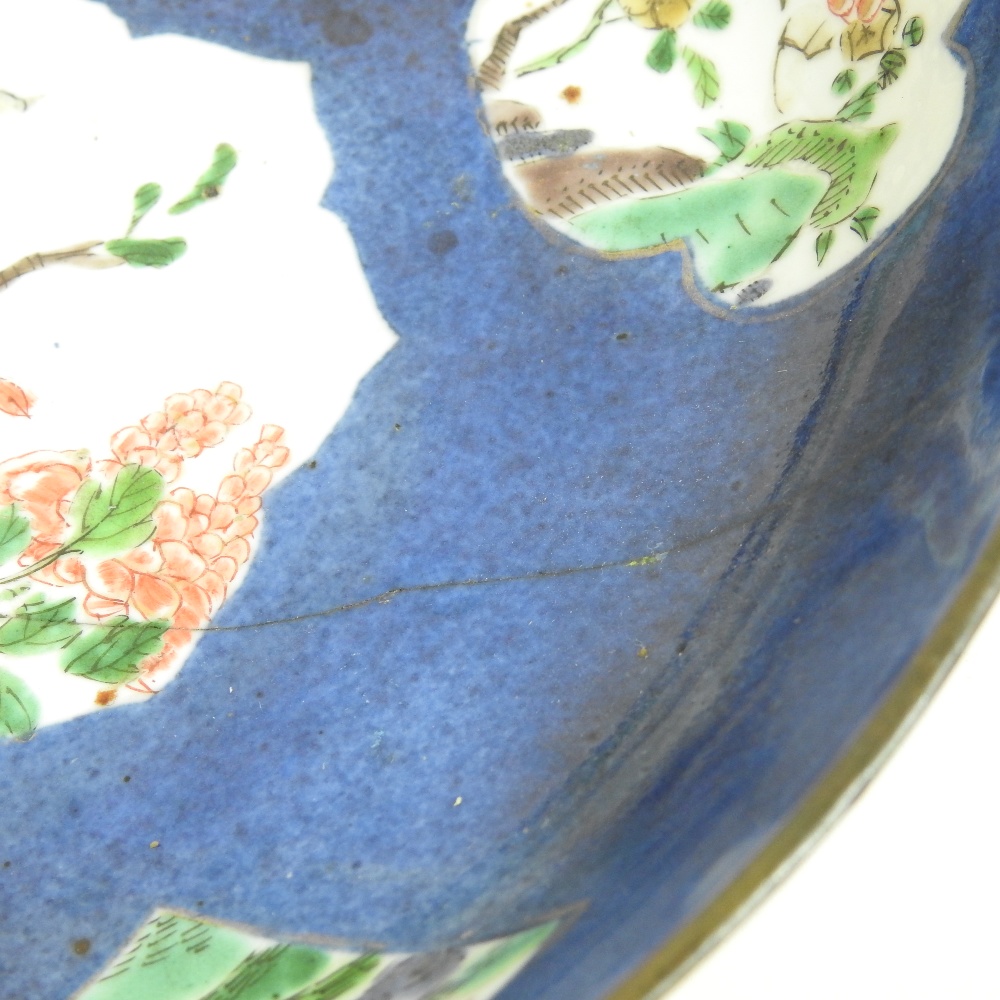 An 18th century Japanese blue glazed dish, reserved with floral panels, on a mottled blue ground, - Image 3 of 8