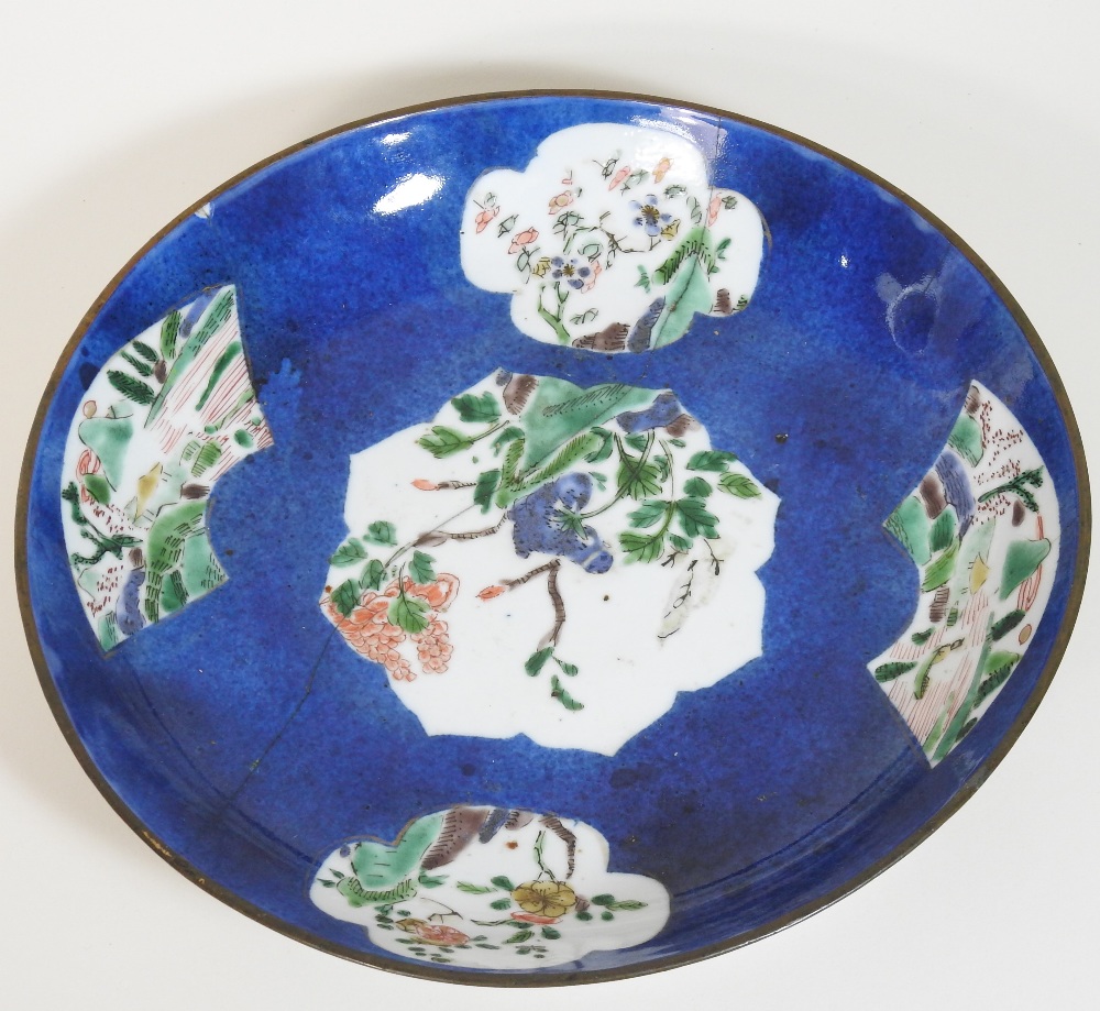 An 18th century Japanese blue glazed dish, reserved with floral panels, on a mottled blue ground, - Image 4 of 8