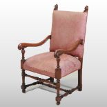 A 19th century oak high back open armchair, with a pink upholstered back and seat,