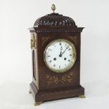 An Edwardian mahogany and cut brass bracket clock, of Regency style, having a painted enamel dial,