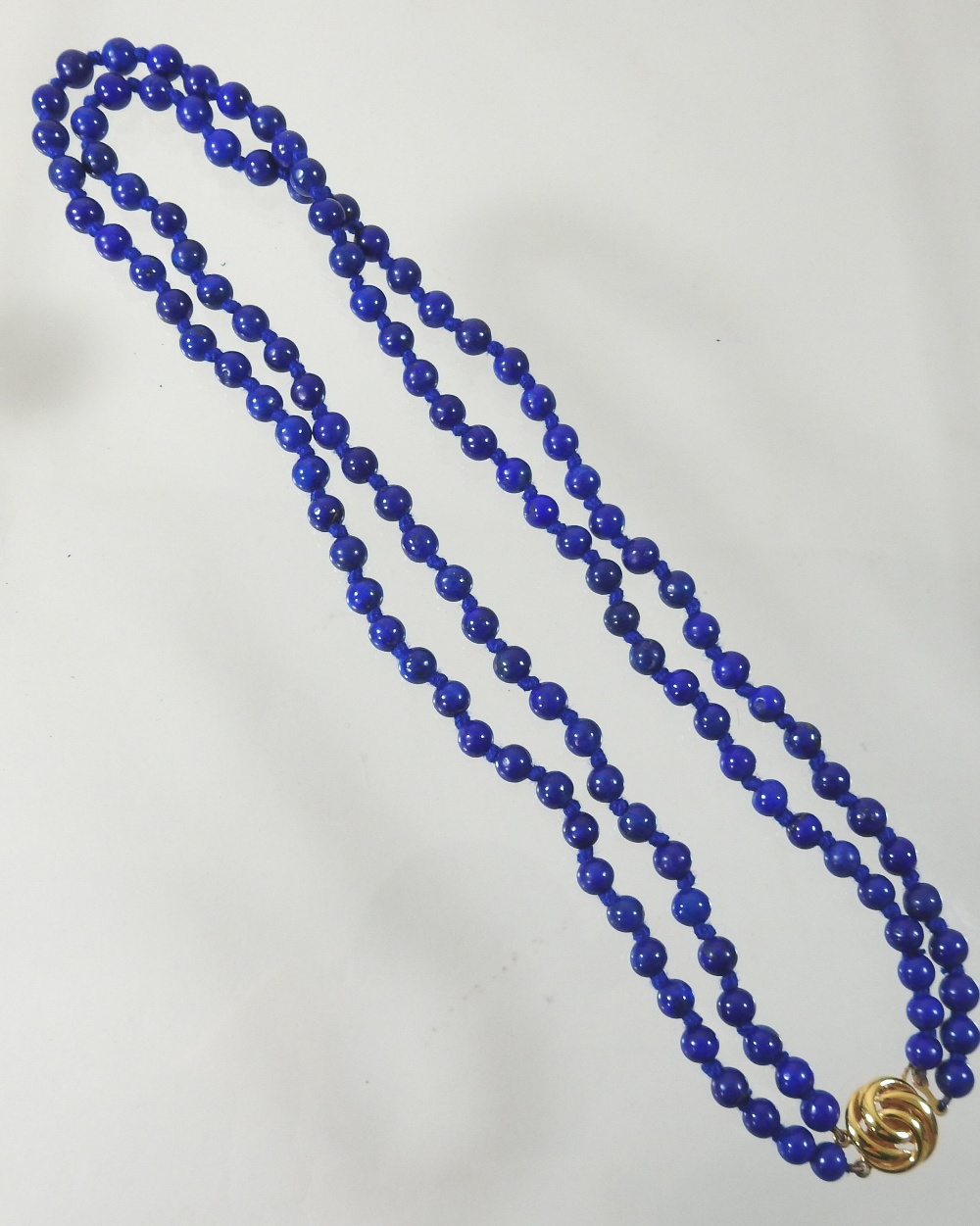 A lapis lazuli double strand bead necklace, with a 9 carat gold clasp, - Image 3 of 5