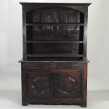 A 19th century continental oak dresser, with a plate rack and cupboards below,