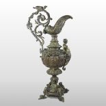 An ornate 19th century gilt bronzed ewer, with mask, figural and scrolled relief decoration,