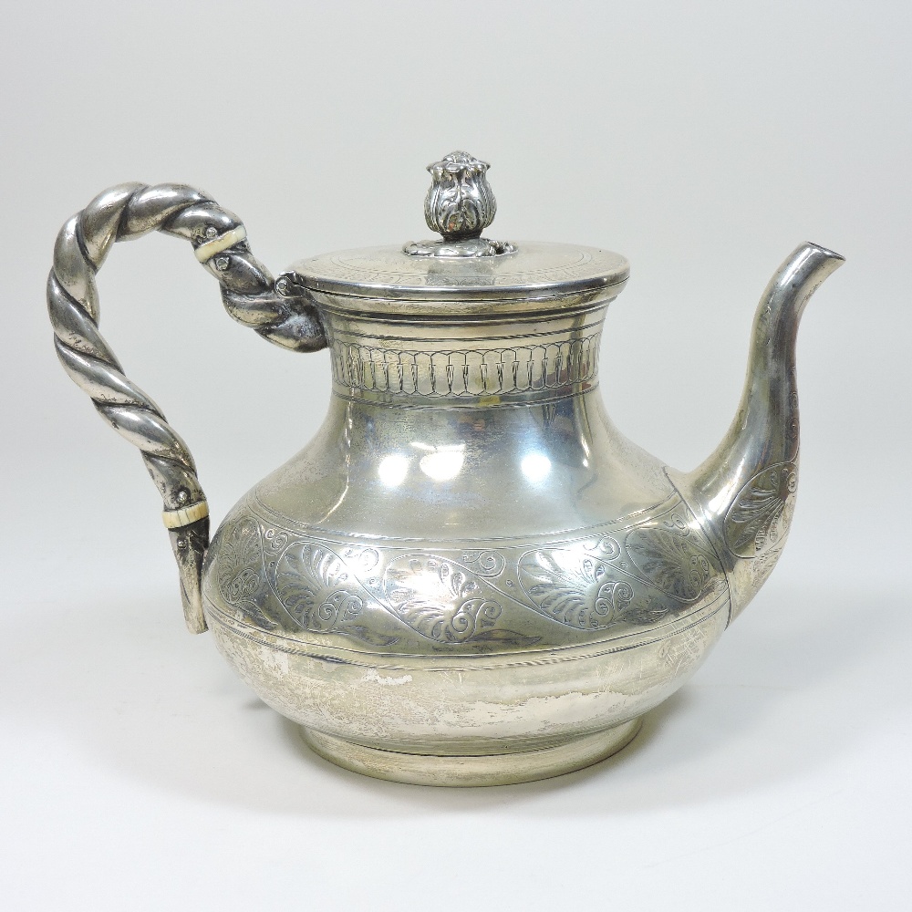 A Victorian silver teapot, of circular baluster form, with a ropetwist handle and hinged lid,