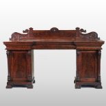 A William IV carved mahogany pedestal sideboard, of inverted breakfront design,