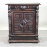 A 19th century heavily carved oak side cabinet, with lion mask decoration,