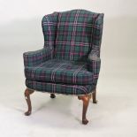 A George I style Irish wing armchair, upholstered in tartan,