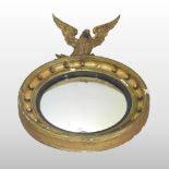 A Regency carved wood and gilt gesso framed convex wall mirror,