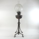 An Art Nouveau bronzed oil lamp, in the manner of W A S Benson, with a Hinks patent for Maple,