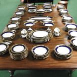 An extensive 20th century Limoges porcelain dinner service, with blue and gilt borders,