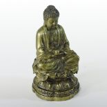 An Asian gilt bronze figure of seated Buddha, with arms folded and legs crossed, on a Lotus base,