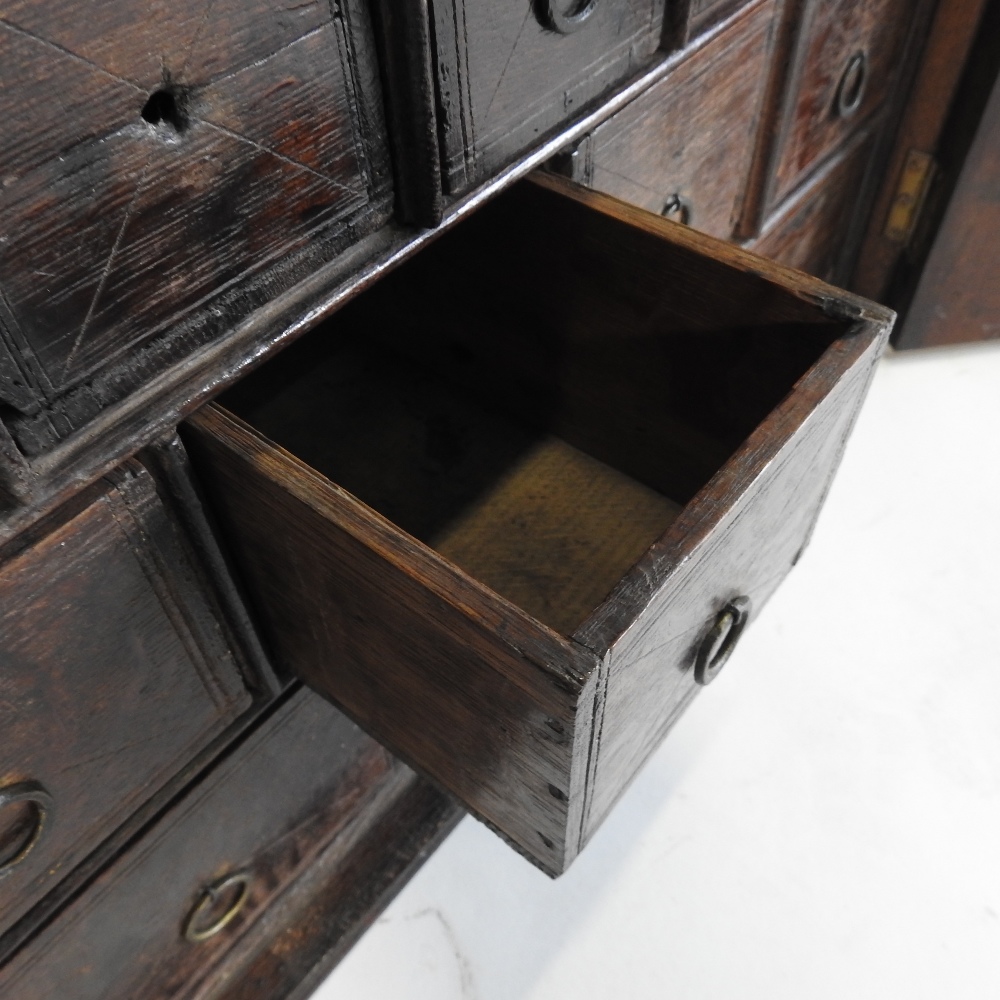 An 18th century carved oak spice cabinet, fitted with an arrangement of twelve short drawers, - Image 7 of 8