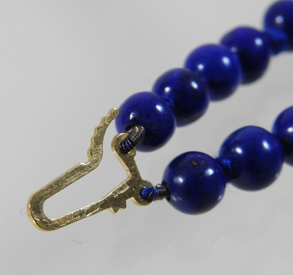 A lapis lazuli double strand bead necklace, with a 9 carat gold clasp, - Image 2 of 5